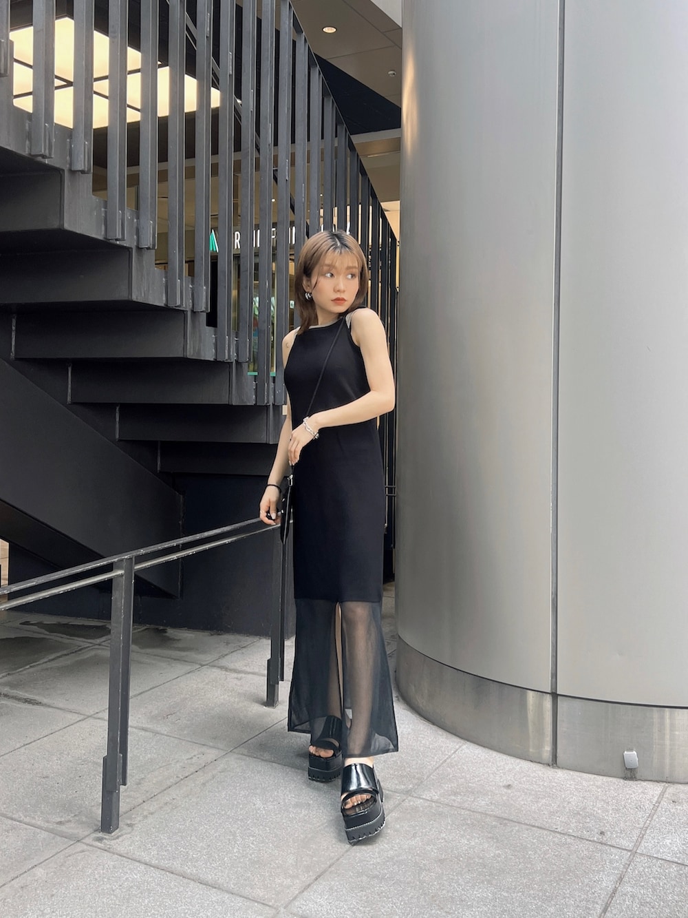 ブラック系のサンダル、ベージュ系のTシャツ/カットソー、ブラック系のワンピースを着用したレディースの夏コーディネートの4枚目の写真