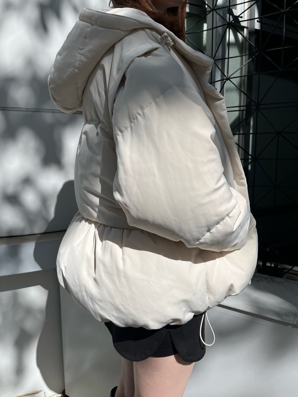 グレー系のスウェット、ホワイト系のブルゾン、ブラック系のスカートを着用したレディースの秋コーディネートの7枚目の写真