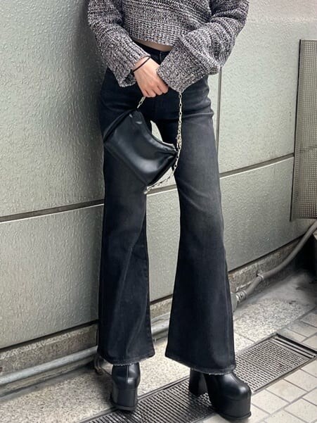 ブラック系のブーツ、ブラック系のデニムパンツ、その他のニット/セーターを着用したレディースの秋コーディネートの5枚目の写真