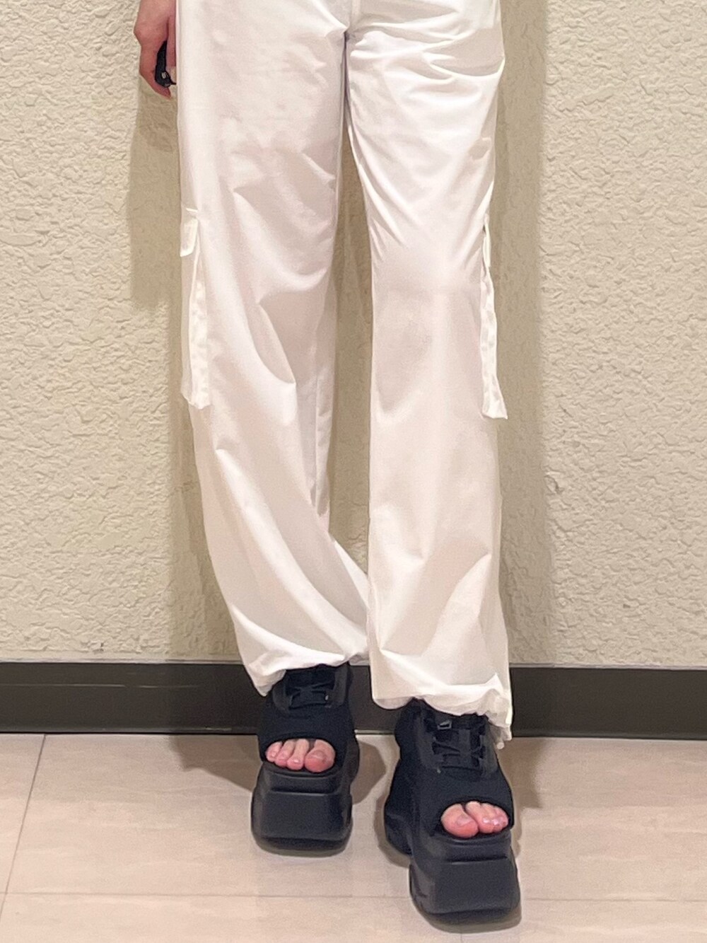 ブラック系のTシャツ/カットソー、ブラック系のサンダル、ホワイト系のその他パンツを着用したレディースの夏コーディネートの7枚目の写真