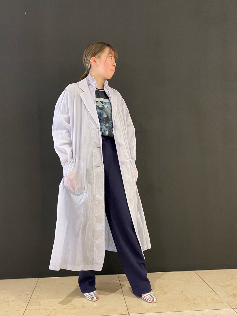 ブルー系のパンツ、ブルー系のハンドバッグ、シルバー系のパンプスを着用したレディースの春コーディネートの3枚目の写真