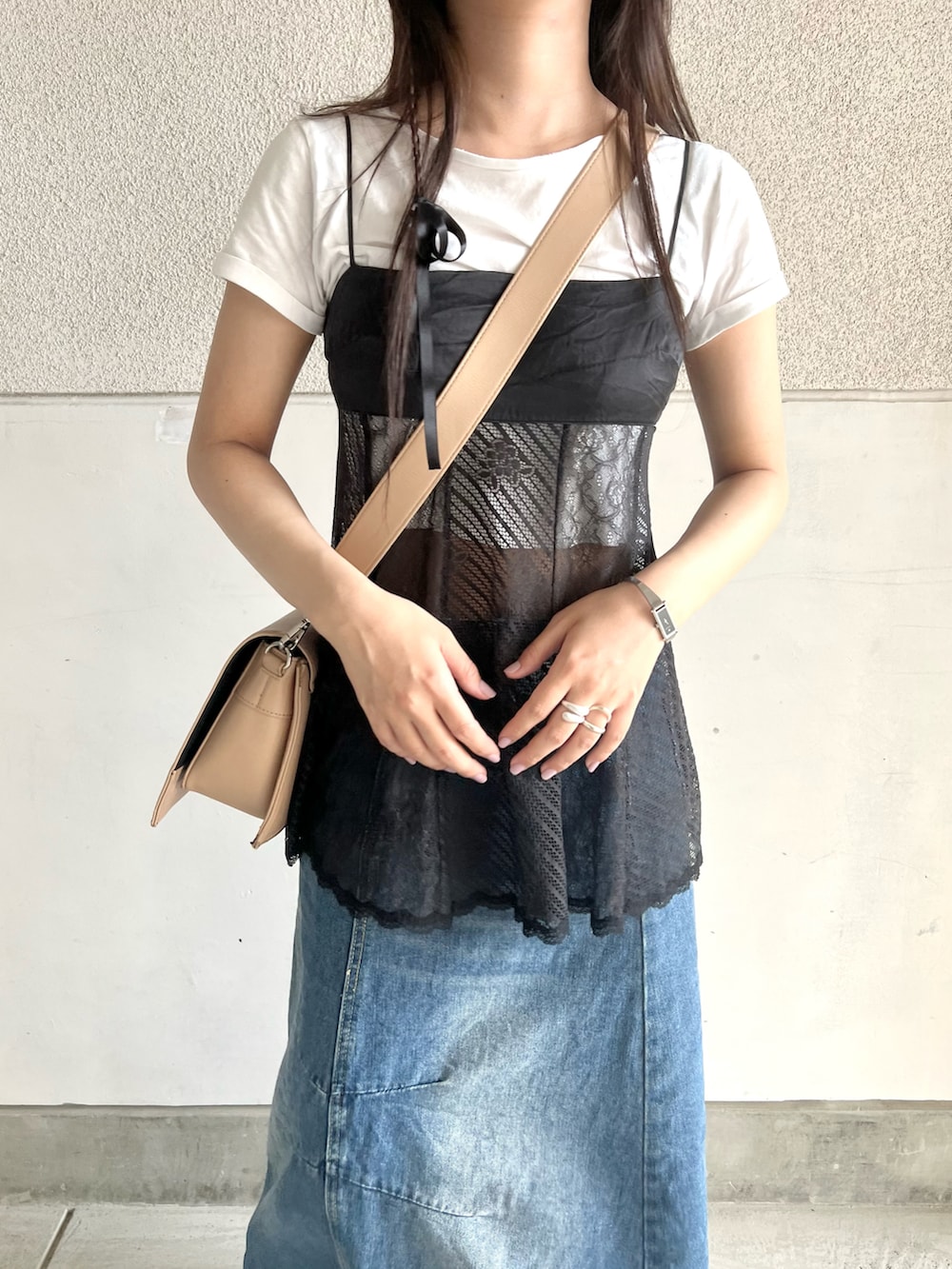 ベージュ系のショルダーバッグ、ブラック系のキャミソール、ホワイト系のTシャツ/カットソーを着用したレディースの夏コーディネートの2枚目の写真