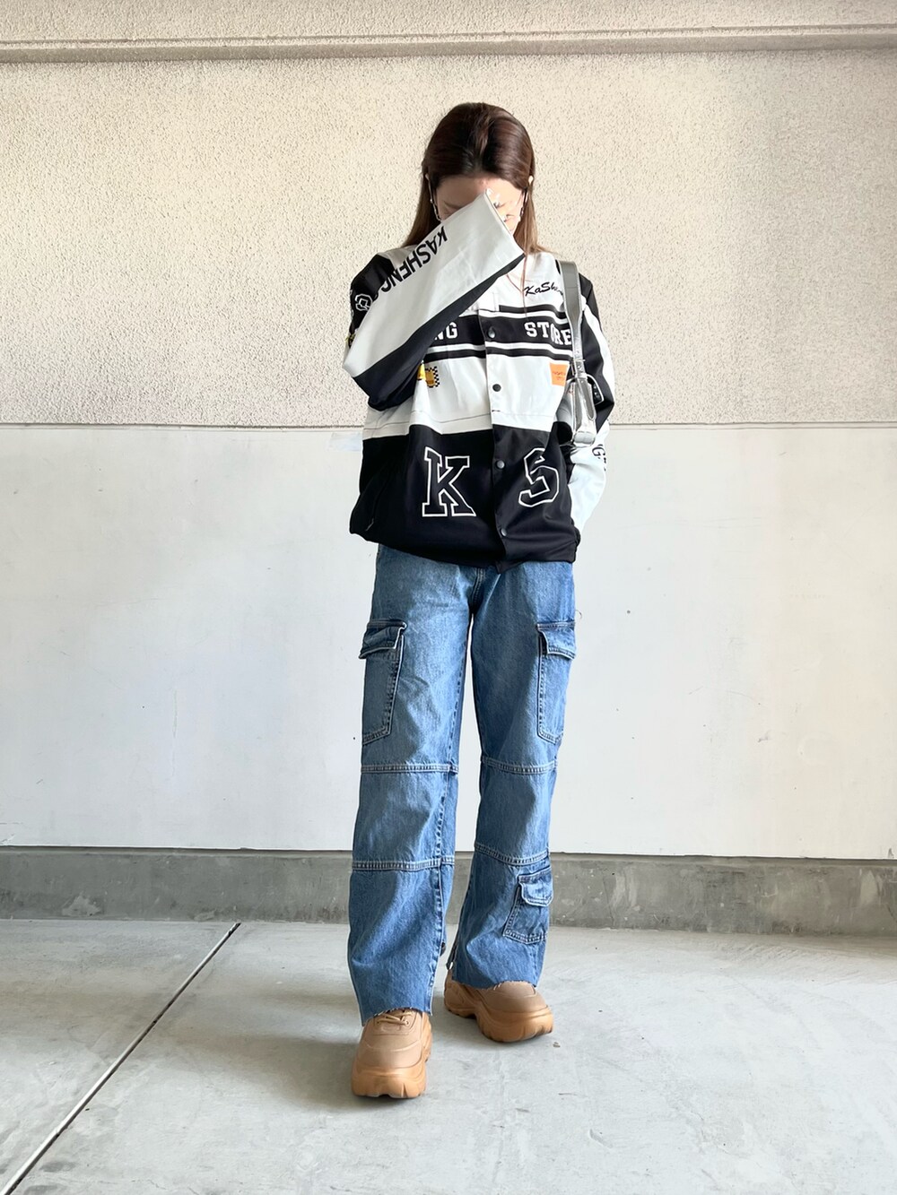 ブルー系のデニムパンツ、イエロー系のスニーカー、ホワイト系のジャケット/アウターを着用したレディースの冬コーディネートの4枚目の写真