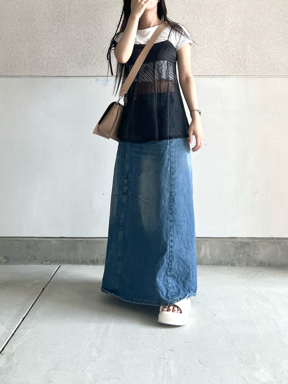 ベージュ系のショルダーバッグ、ブラック系のキャミソール、ホワイト系のTシャツ/カットソーを着用したレディースの夏コーディネートの3枚目の写真