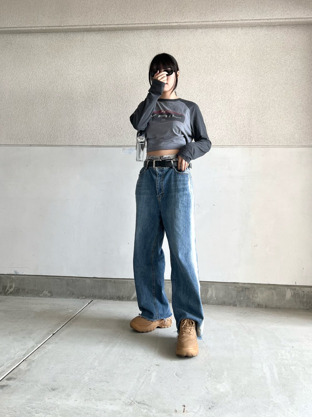 イエロー系のスニーカー、ブルー系のデニムパンツ、グレー系のトップスを着用したレディースの春コーディネートの5枚目の写真