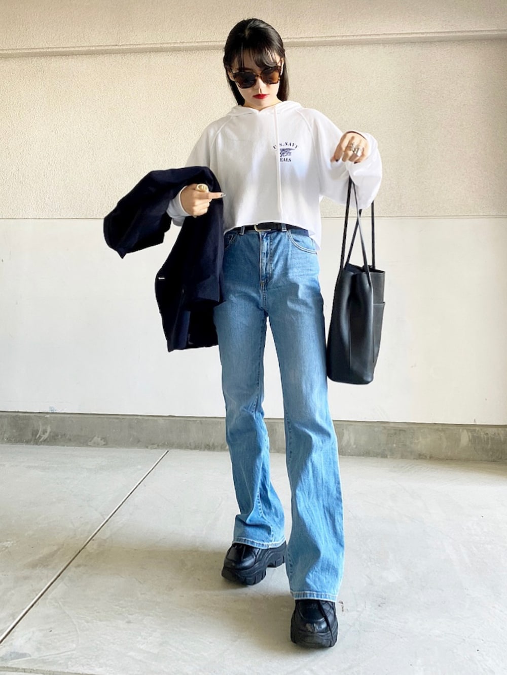 ブルー系のパンツ、ブラック系のスニーカー、ブルー系のテーラードジャケットを着用したレディースの春コーディネートの2枚目の写真