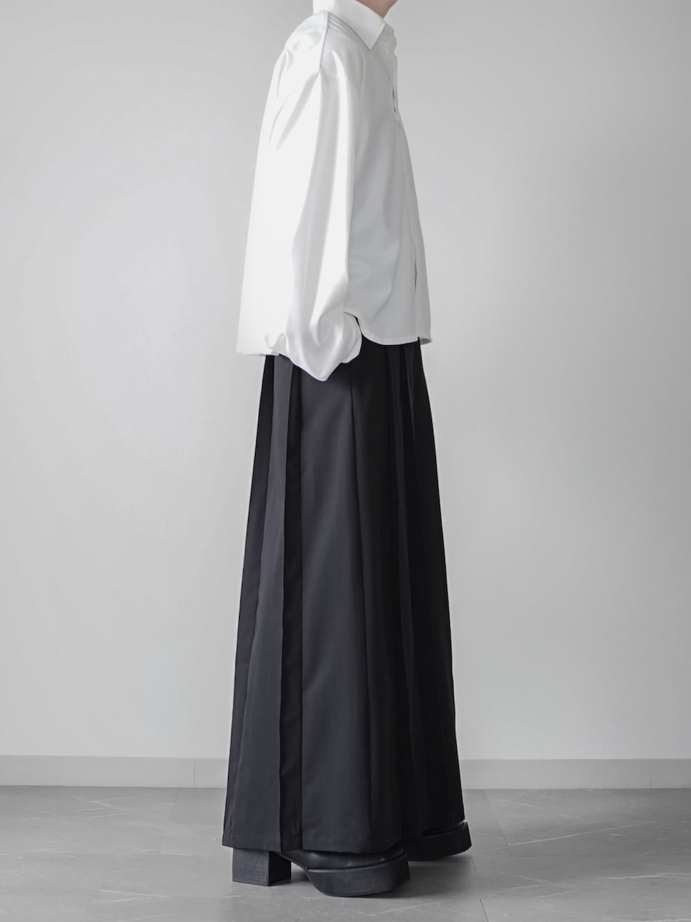 ブラック系のハンドバッグ、ホワイト系のシャツ/ブラウス、ブラック系のスラックスを着用したメンズの秋コーディネートの2枚目の写真