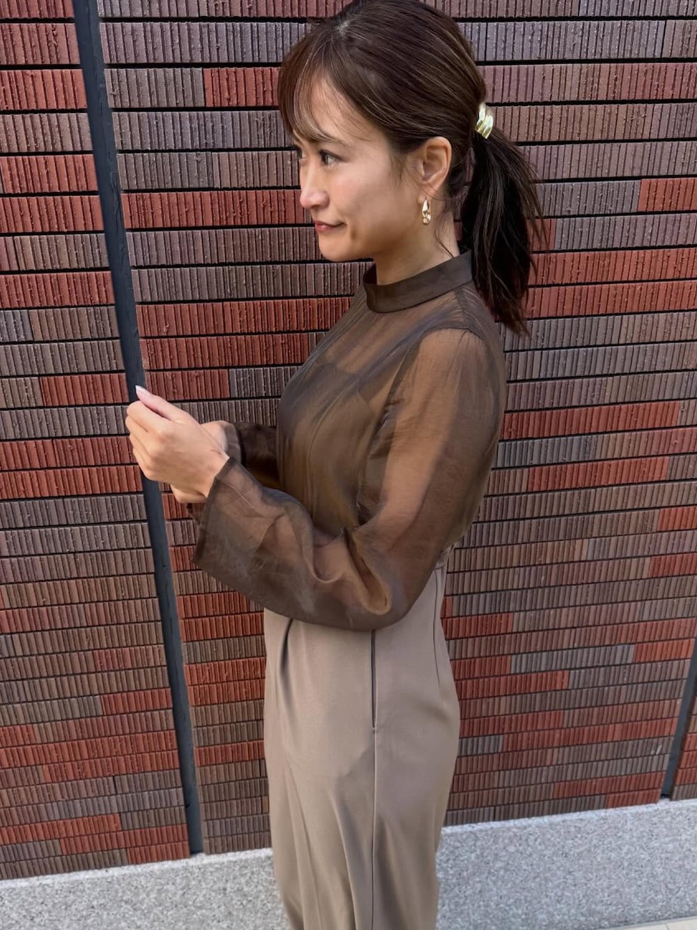 ブラウン系のスーツセットを着用したレディースの冬コーディネートの3枚目の写真