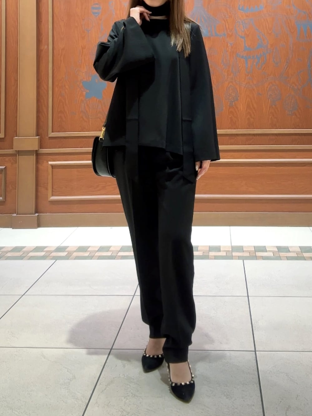 ブラック系のスーツセットを着用したレディースの冬コーディネートの9枚目の写真