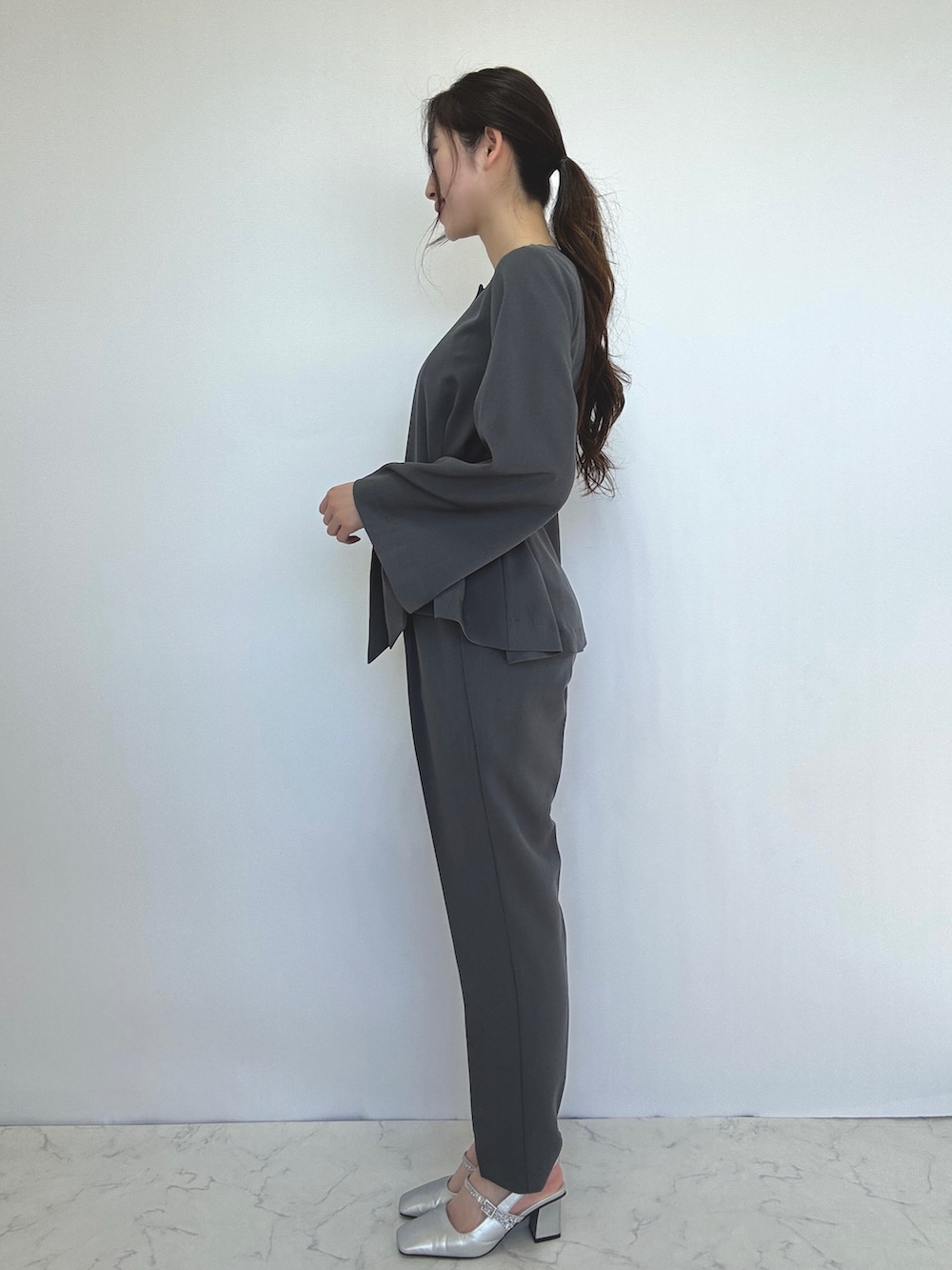 グレー系のスーツセットを着用したレディースの冬コーディネートの2枚目の写真
