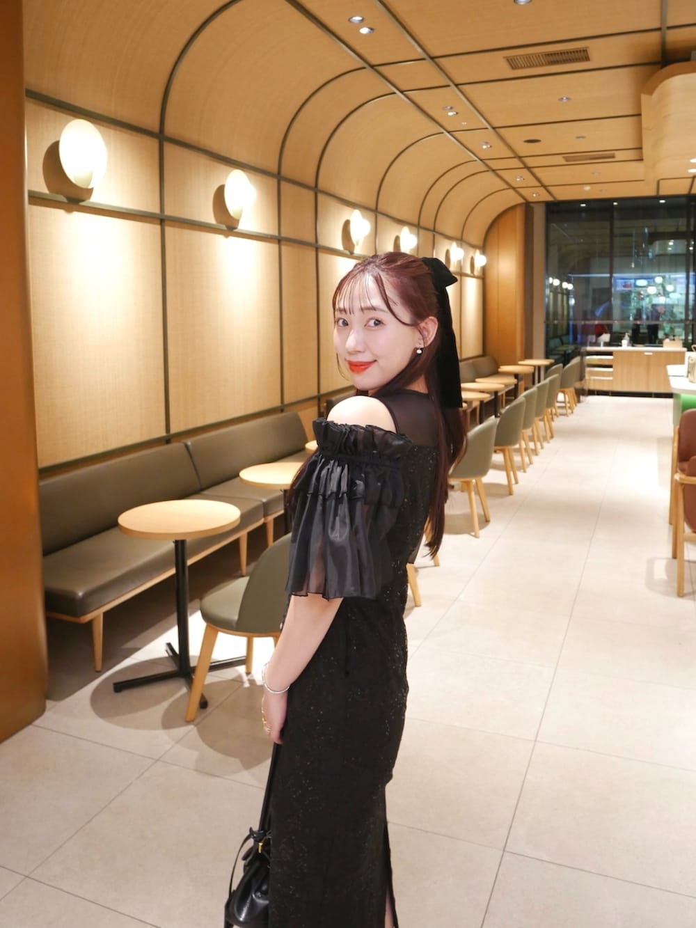 ブラック系のドレスを着用したレディースの冬コーディネートの2枚目の写真