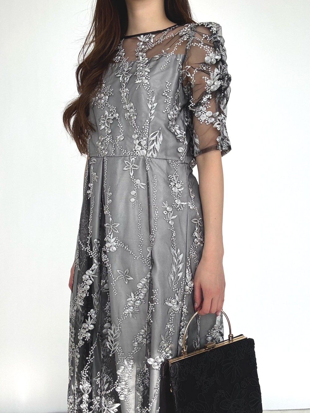 ブラック系のドレス、ブラック系のパンプスを着用したレディースの秋コーディネートの4枚目の写真