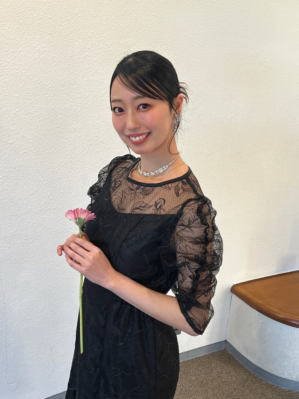 ブラック系のドレスを着用したレディースの春コーディネートの2枚目の写真