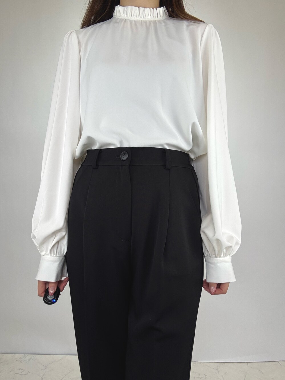 ブラック系のスーツセットを着用したレディースの冬コーディネートの5枚目の写真