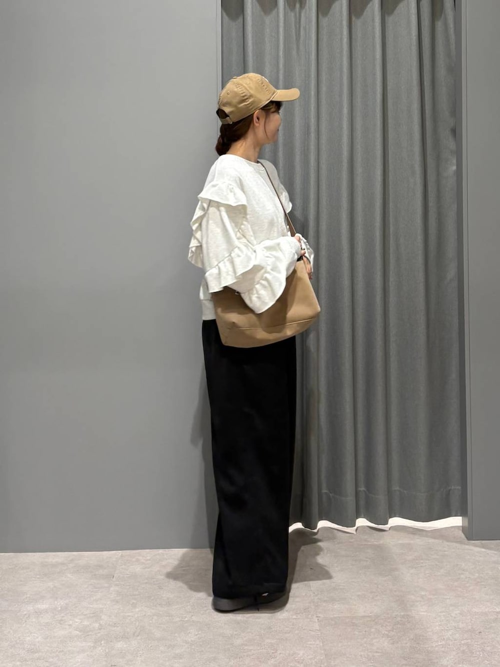 ブルー系のスニーカー、ベージュ系のショルダーバッグ、ブラック系のその他パンツを着用したレディースの秋コーディネートの4枚目の写真