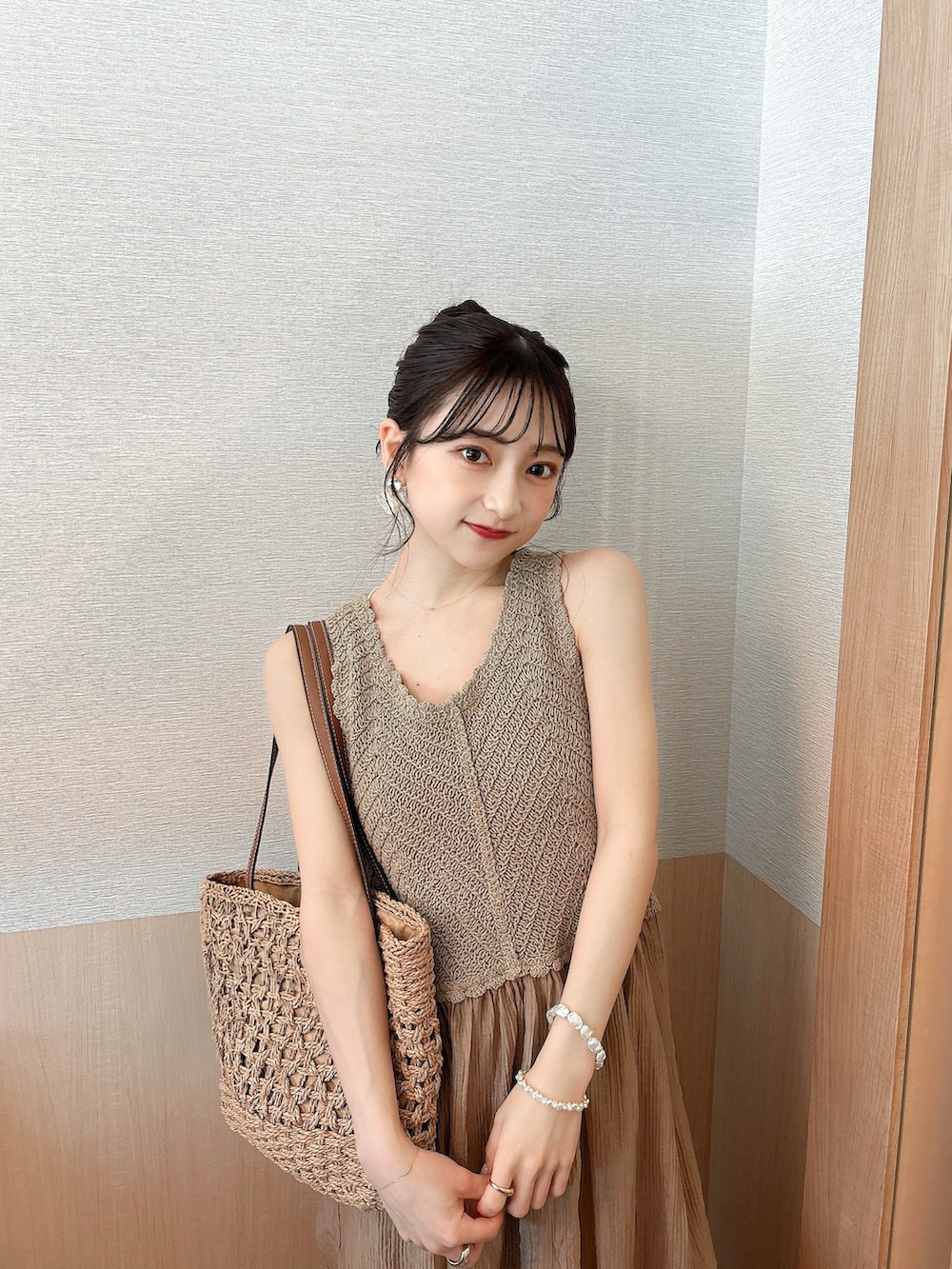 ホワイト系のカーディガン/ボレロ、ブラウン系のワンピース、ベージュ系のサンダルを着用したレディースの夏コーディネートの3枚目の写真