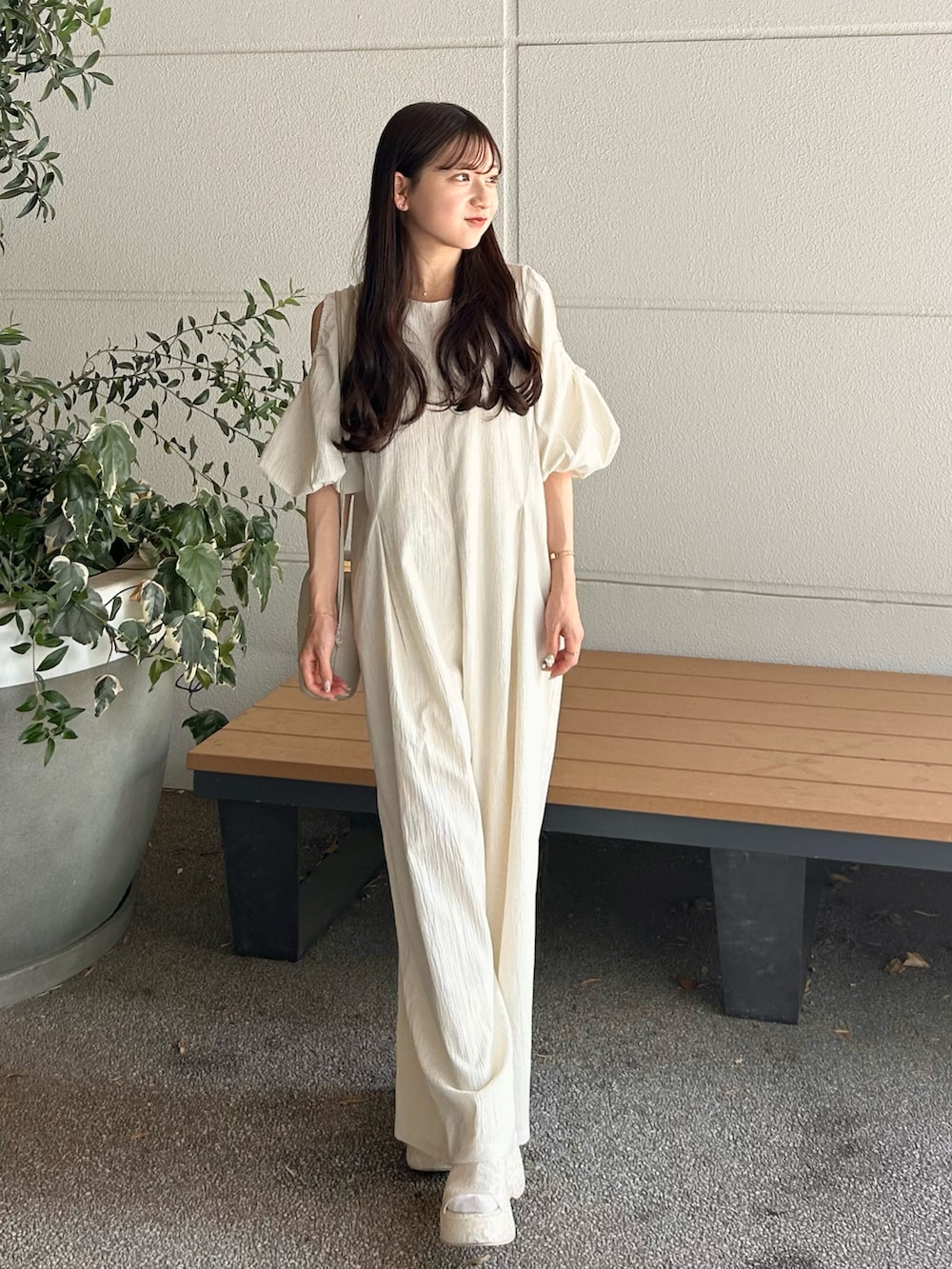 ホワイト系のつなぎ/オールインワン、ベージュ系のバッグ、ホワイト系のサンダルを着用したレディースの春コーディネートの2枚目の写真