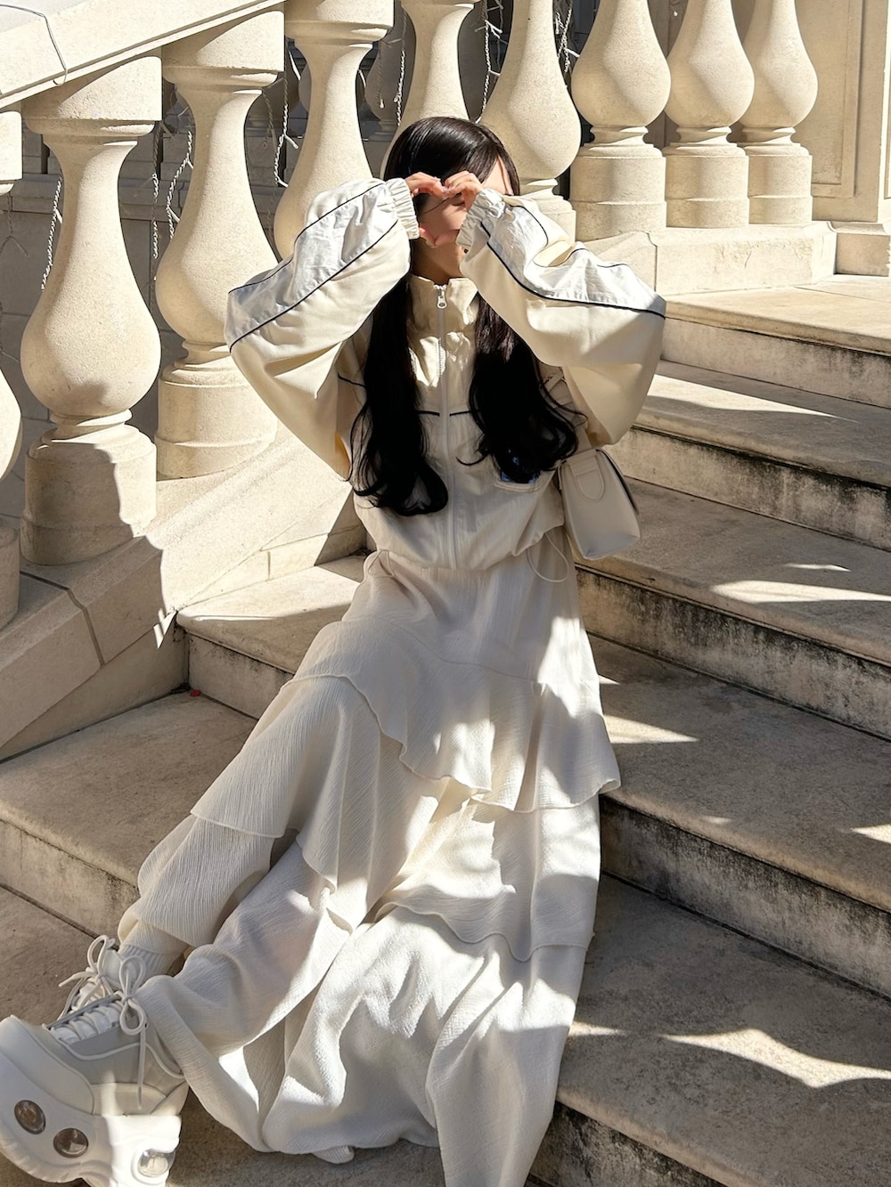 ホワイト系のワンピース/ドレス、ホワイト系のスニーカー、ホワイト系のブルゾンを着用したレディースの春コーディネートの3枚目の写真