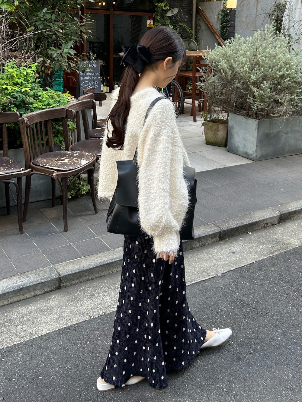 ホワイト系のカーディガン/ボレロ、ブラック系のショルダーバッグ、ホワイト系のサンダルを着用したレディースの秋コーディネートの3枚目の写真