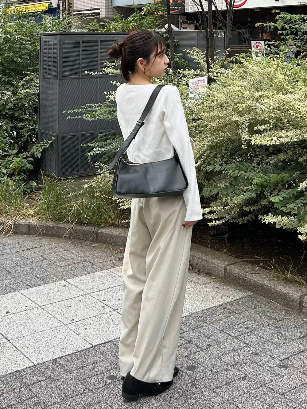ホワイト系のスラックス、ホワイト系のカーディガン/ボレロ、ブラック系のトートバッグを着用したレディースの秋コーディネートの4枚目の写真