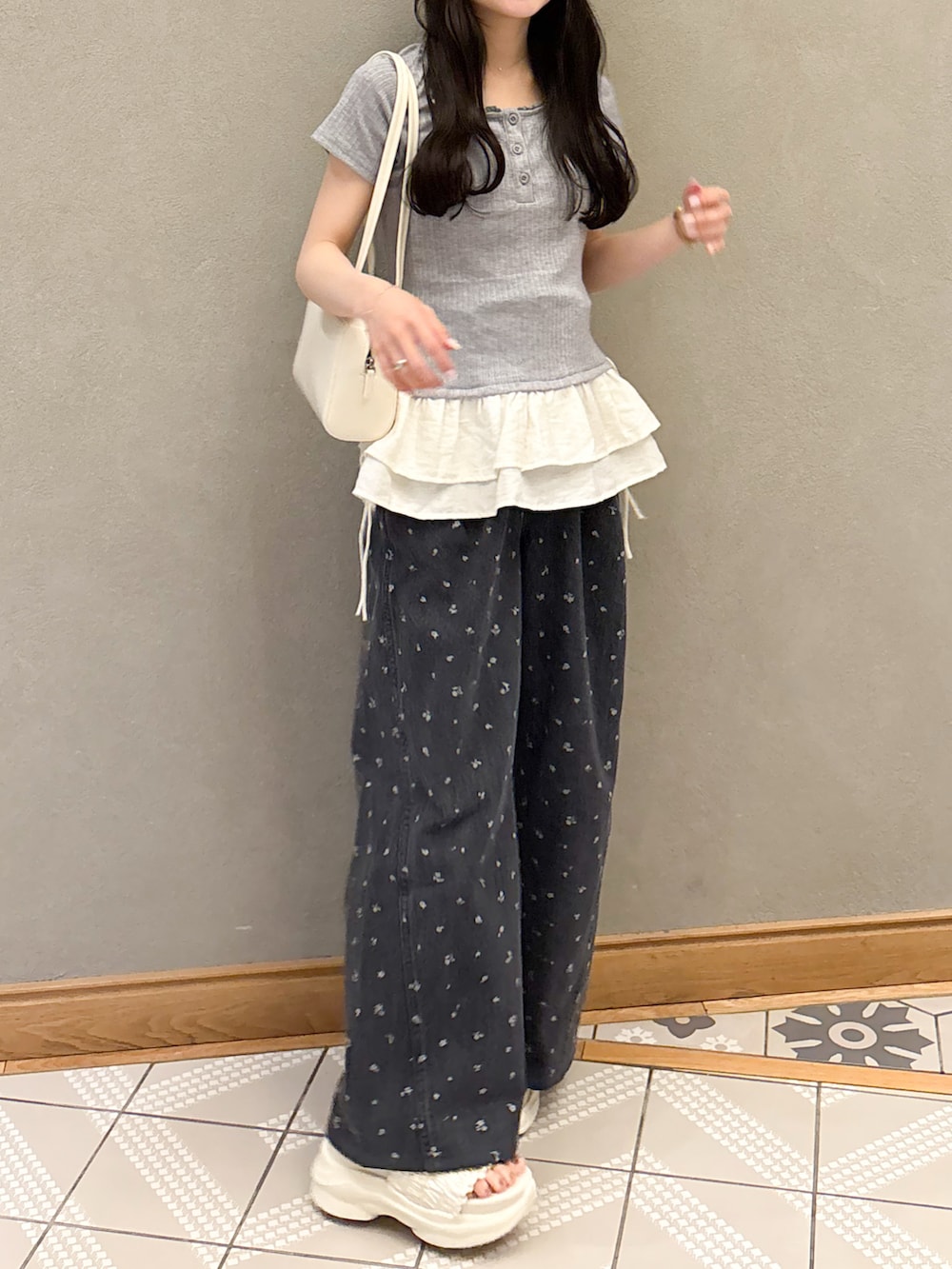 グレー系のTシャツ/カットソー、ホワイト系のショルダーバッグ、ブラック系のデニムパンツを着用したレディースの春コーディネートの3枚目の写真