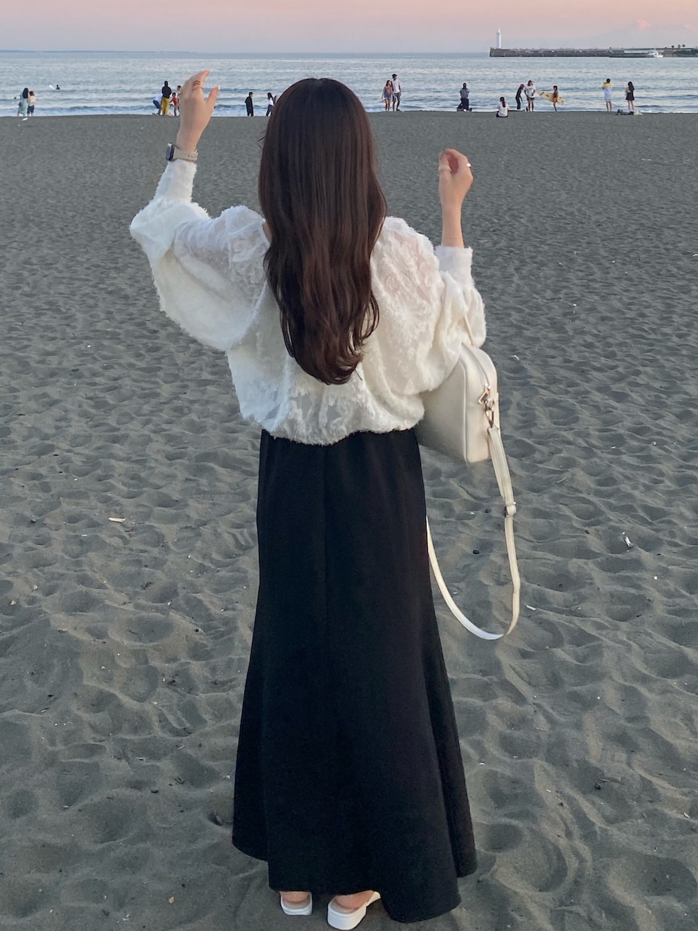 ホワイト系のシューズ、ブラック系のスカート、ホワイト系のシャツ/ブラウスを着用したレディースの秋コーディネートの2枚目の写真