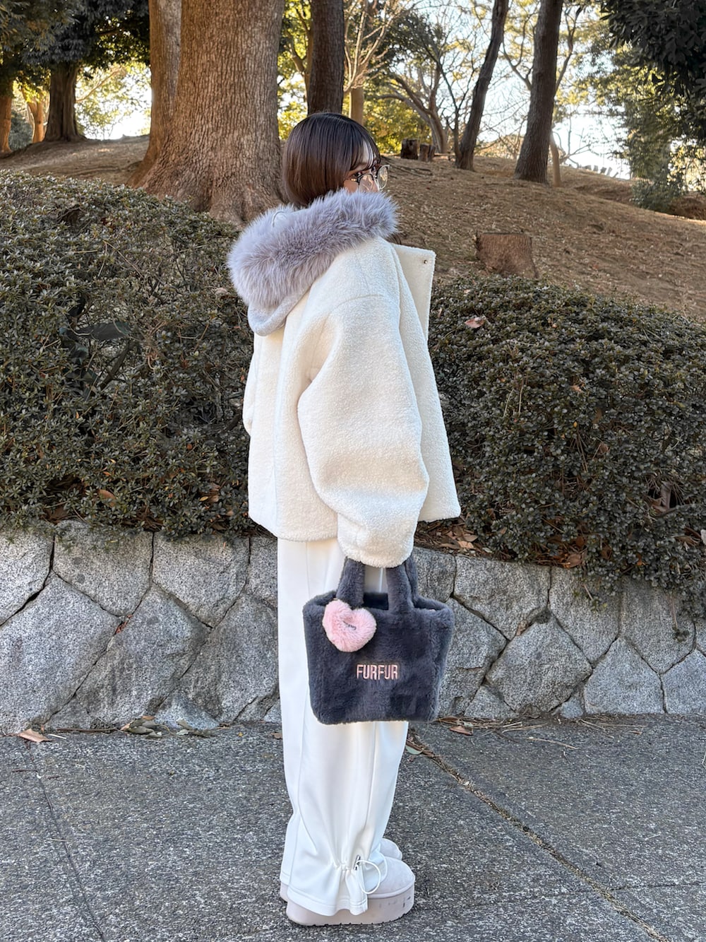 ホワイト系のブルゾン、ホワイト系のTシャツ/カットソー、ホワイト系のスウェットパンツを着用したレディースの冬コーディネートの5枚目の写真