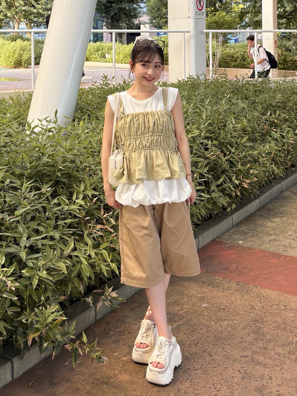 ホワイト系のTシャツ/カットソー、グリーン系のキャミソール、ベージュ系のその他パンツを着用したレディースの夏コーディネートの3枚目の写真