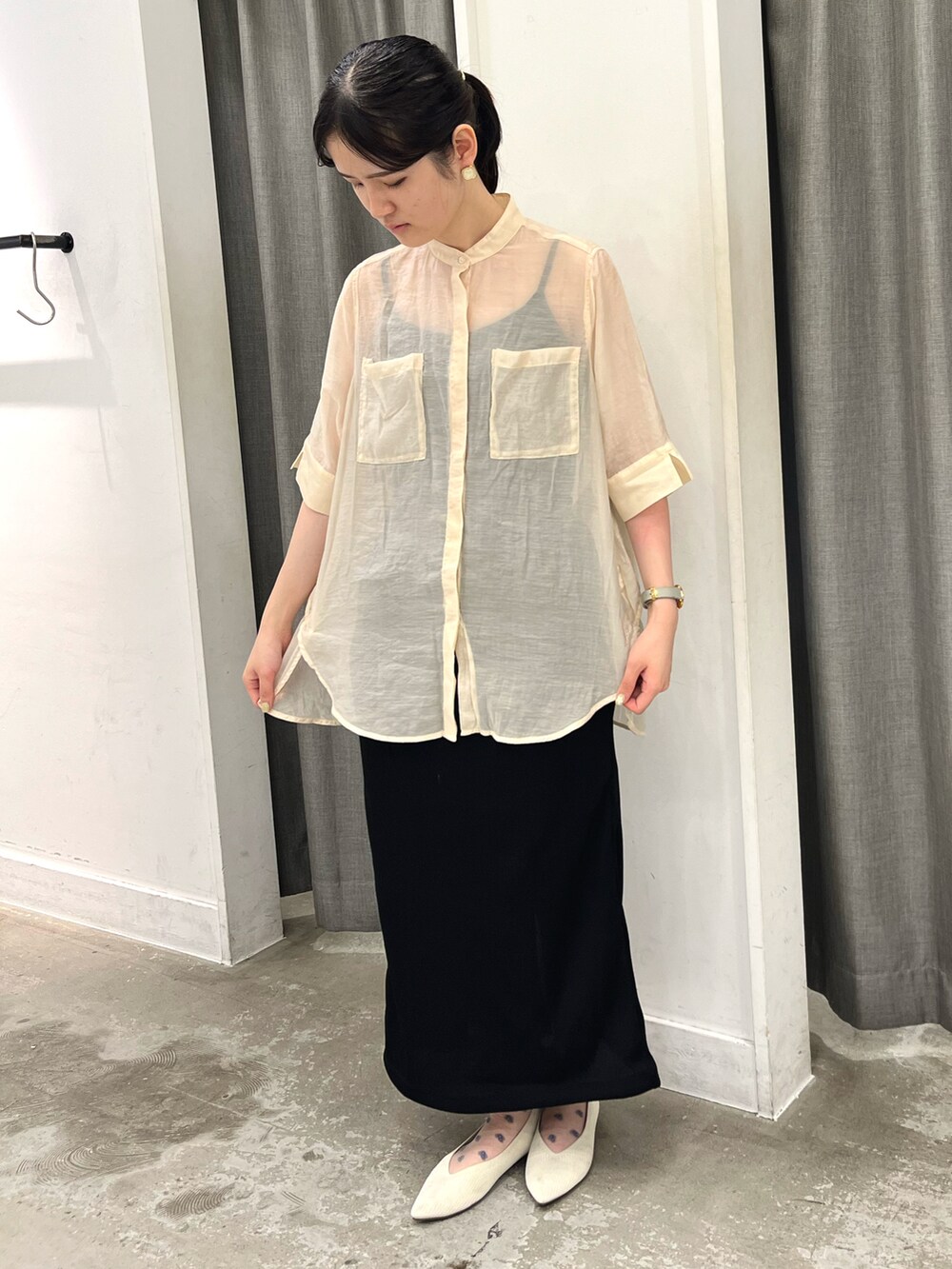 ホワイト系のシャツ/ブラウス、ブラック系のスカートを着用したレディースの夏コーディネートの2枚目の写真