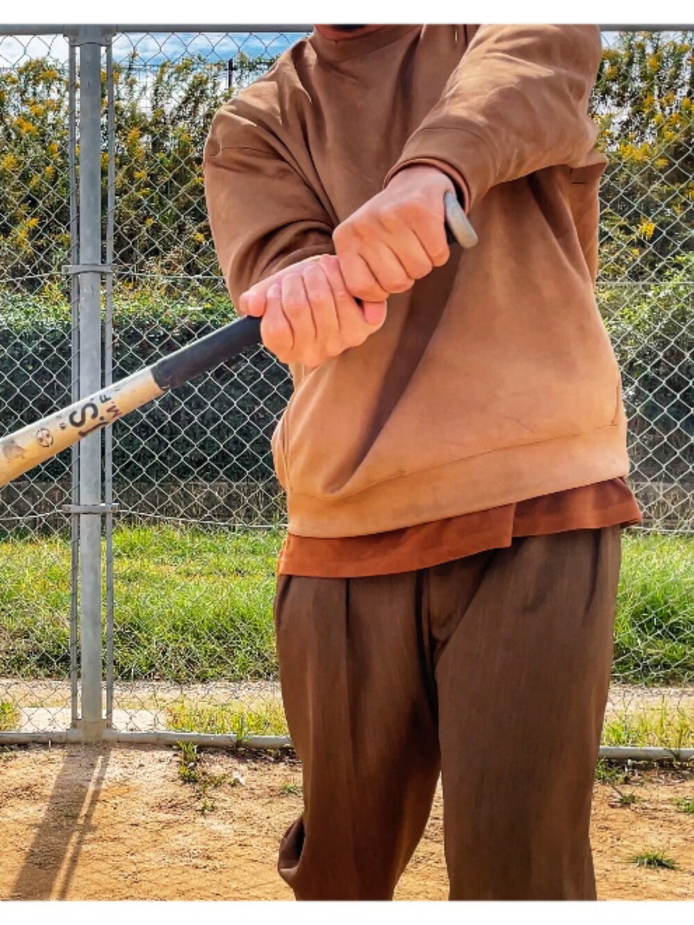 ブラウン系のTシャツ/カットソー、グリーン系のスラックスを着用したメンズの秋コーディネートの2枚目の写真