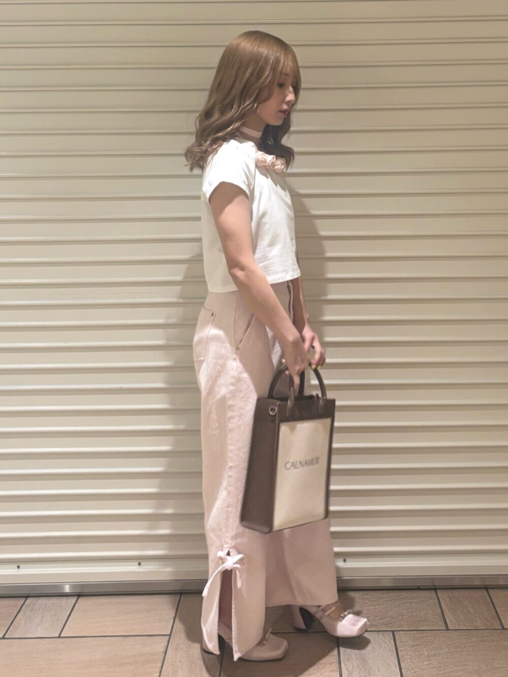 ピンク系のデニムパンツ、ピンク系のTシャツ/カットソー、ピンク系のパンプスを着用したレディースの春コーディネートの2枚目の写真