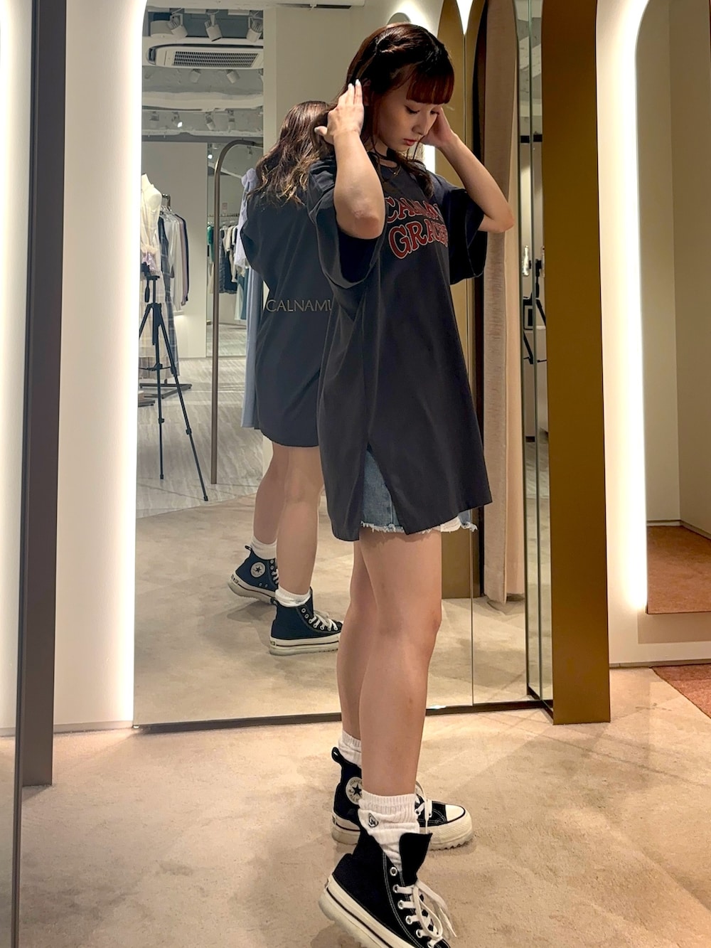 ブラック系のTシャツ/カットソー、ホワイト系のスニーカーを着用したレディースの夏コーディネートの3枚目の写真