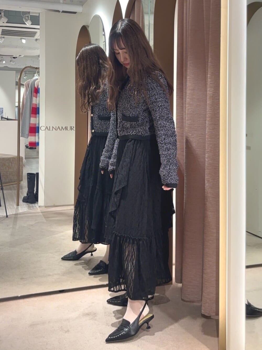 ブラック系のサンダル、ブラック系のスカート、ブラック系のカーディガン/ボレロを着用したレディースの春コーディネートの4枚目の写真