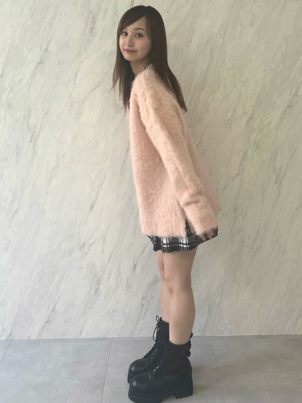 ホワイト系のニット/セーター、レッド系のスカート、ブラック系のブーツを着用したレディースの夏コーディネートの4枚目の写真