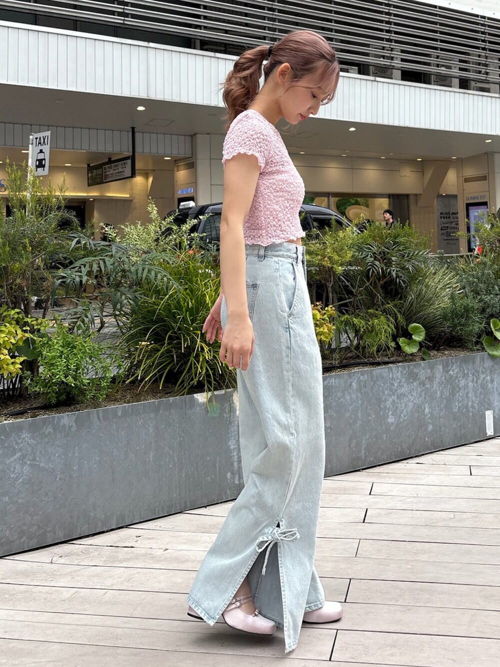 ブルー系のデニムパンツ、ピンク系のTシャツ/カットソー、ピンク系のパンプスを着用したレディースの春コーディネートの4枚目の写真