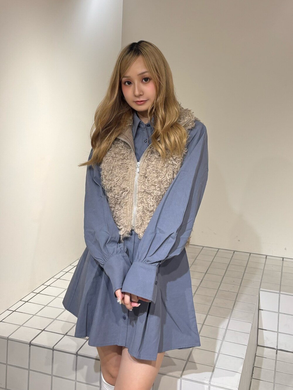 ブルー系のシャツワンピース、ベージュ系のブルゾン、ブラウン系のブーツを着用したレディースの秋コーディネートの6枚目の写真