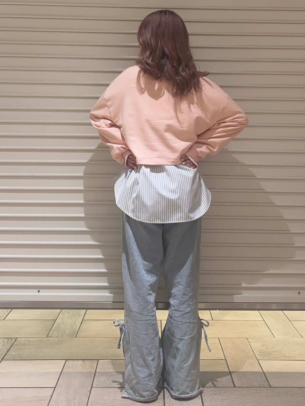 ブルー系のデニムパンツ、ブルー系のシャツ/ブラウス、ピンク系のスウェットを着用したレディースの春コーディネートの6枚目の写真