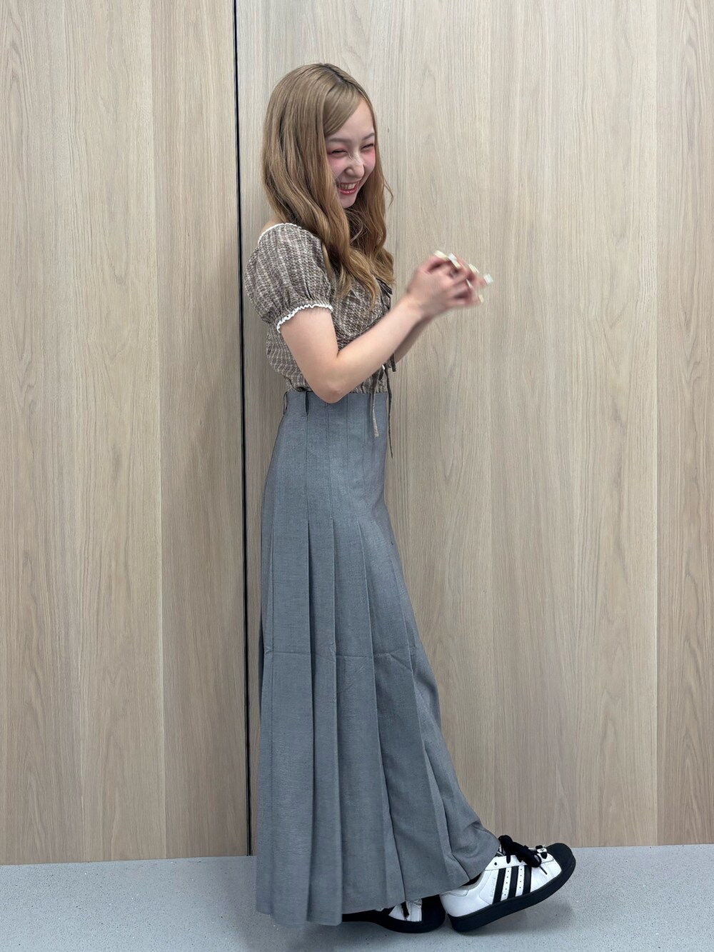 グレー系のスカート、ブラウン系のシャツ/ブラウスを着用したレディースの夏コーディネートの2枚目の写真