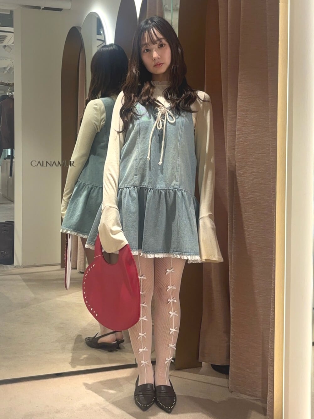 ブラウン系のサンダル、ブルー系のワンピース、ホワイト系のTシャツ/カットソーを着用したレディースの春コーディネートの5枚目の写真