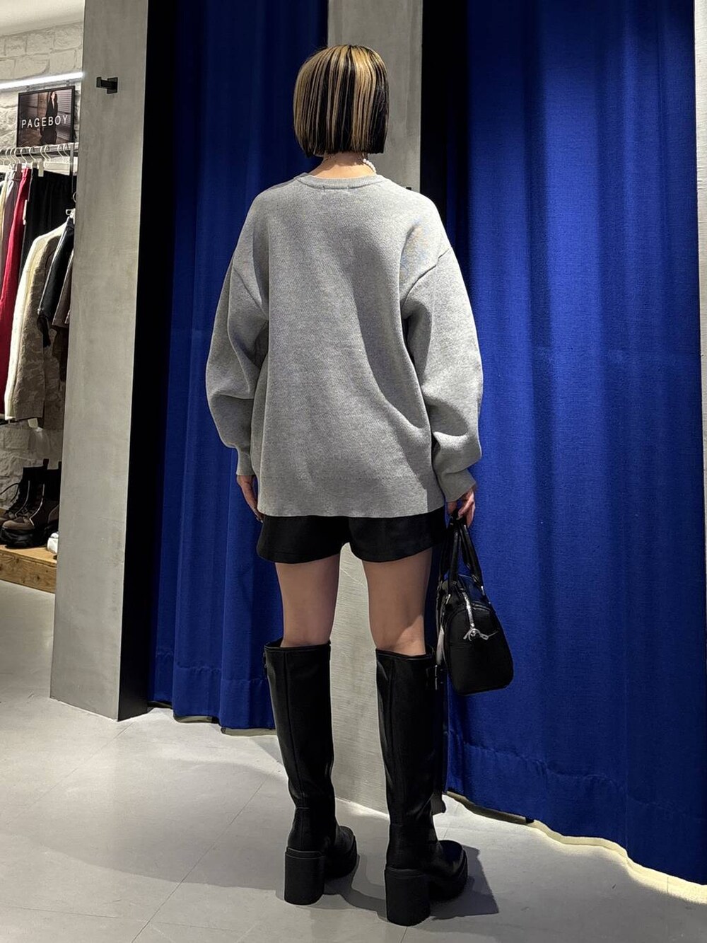 ブラック系のブーツ、ブラック系のその他パンツ、ブラック系のボストンバッグを着用したレディースの冬コーディネートの5枚目の写真