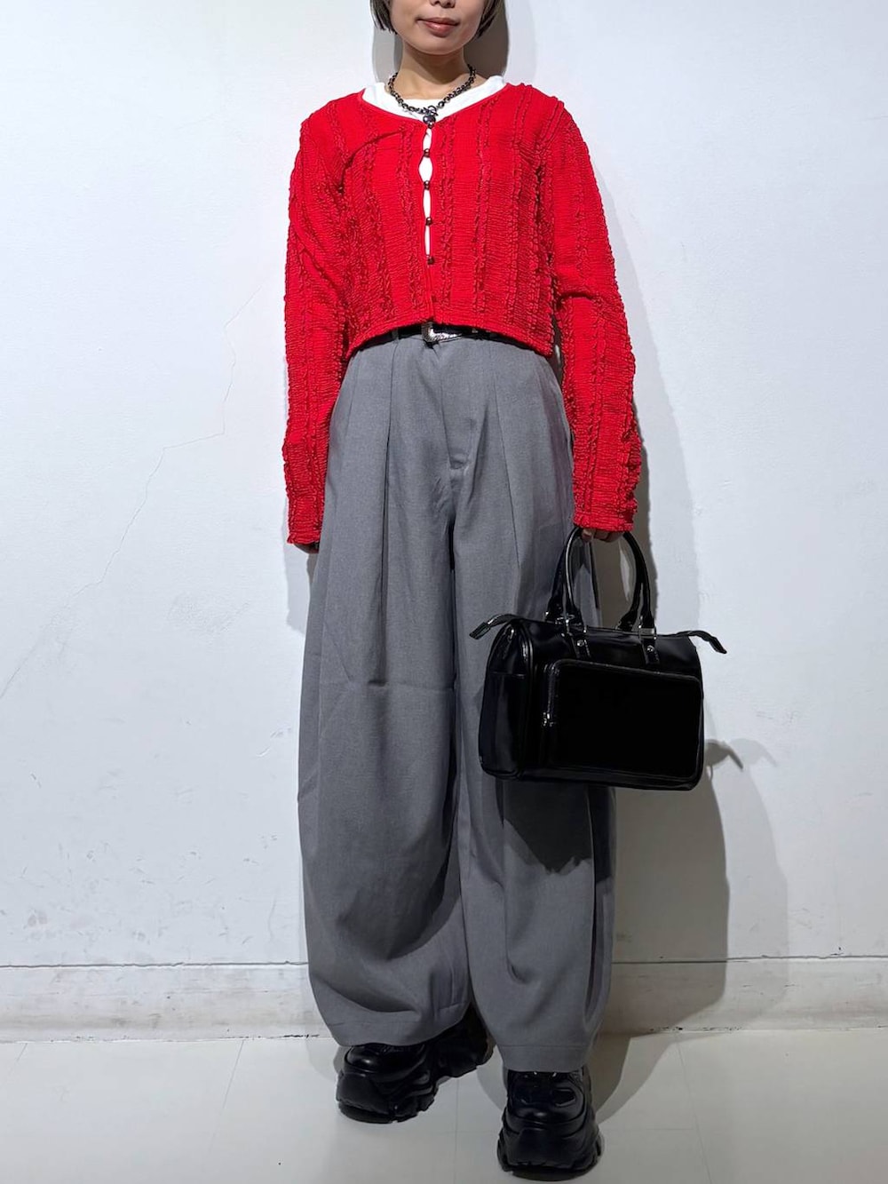 ブラック系のショルダーバッグ、ホワイト系のTシャツ/カットソー、レッド系のTシャツ/カットソーを着用したレディースの春コーディネートの2枚目の写真