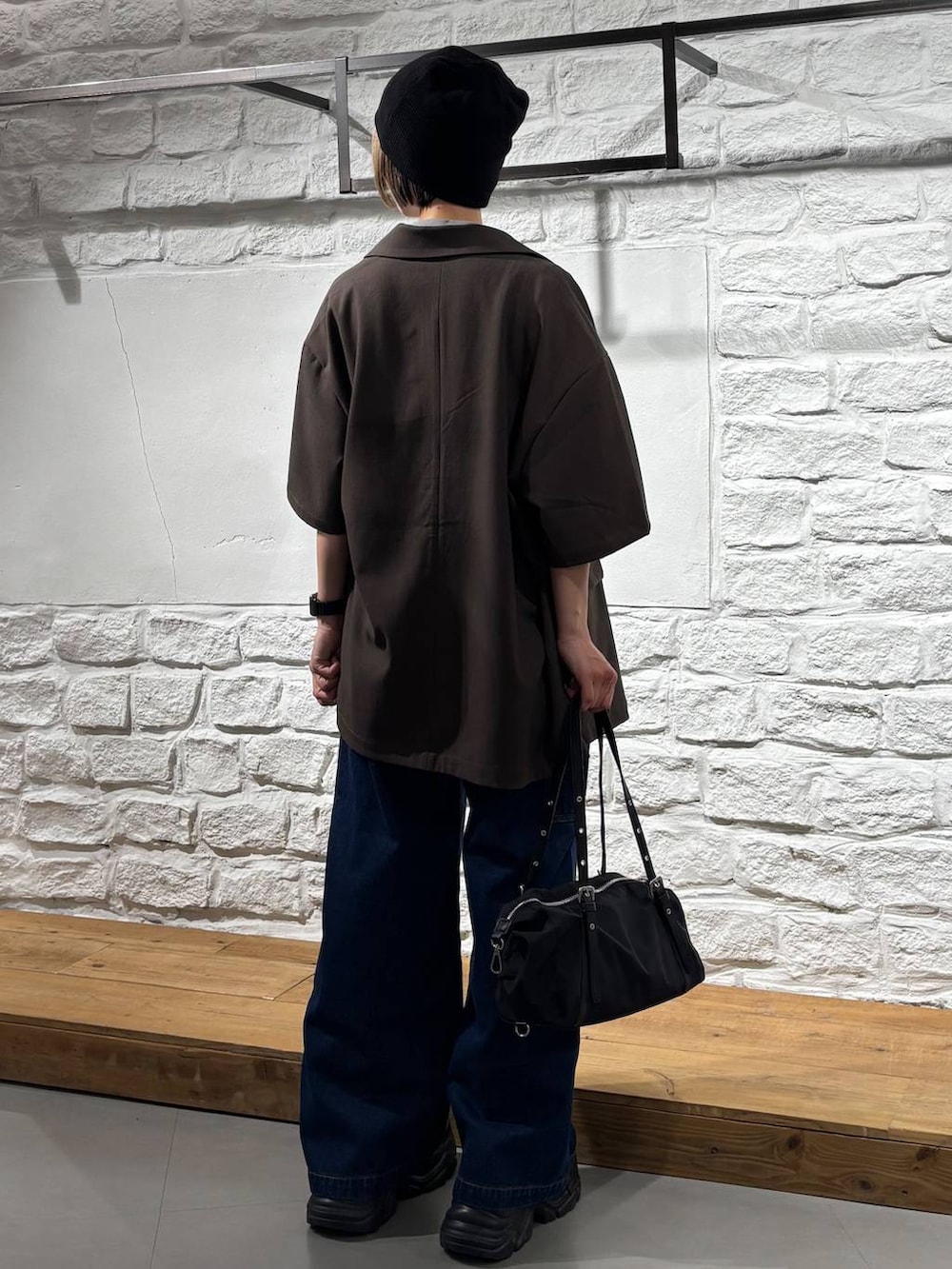 ブラック系のスニーカー、ブルー系のデニムパンツ、その他のTシャツ/カットソーを着用したレディースの春コーディネートの5枚目の写真