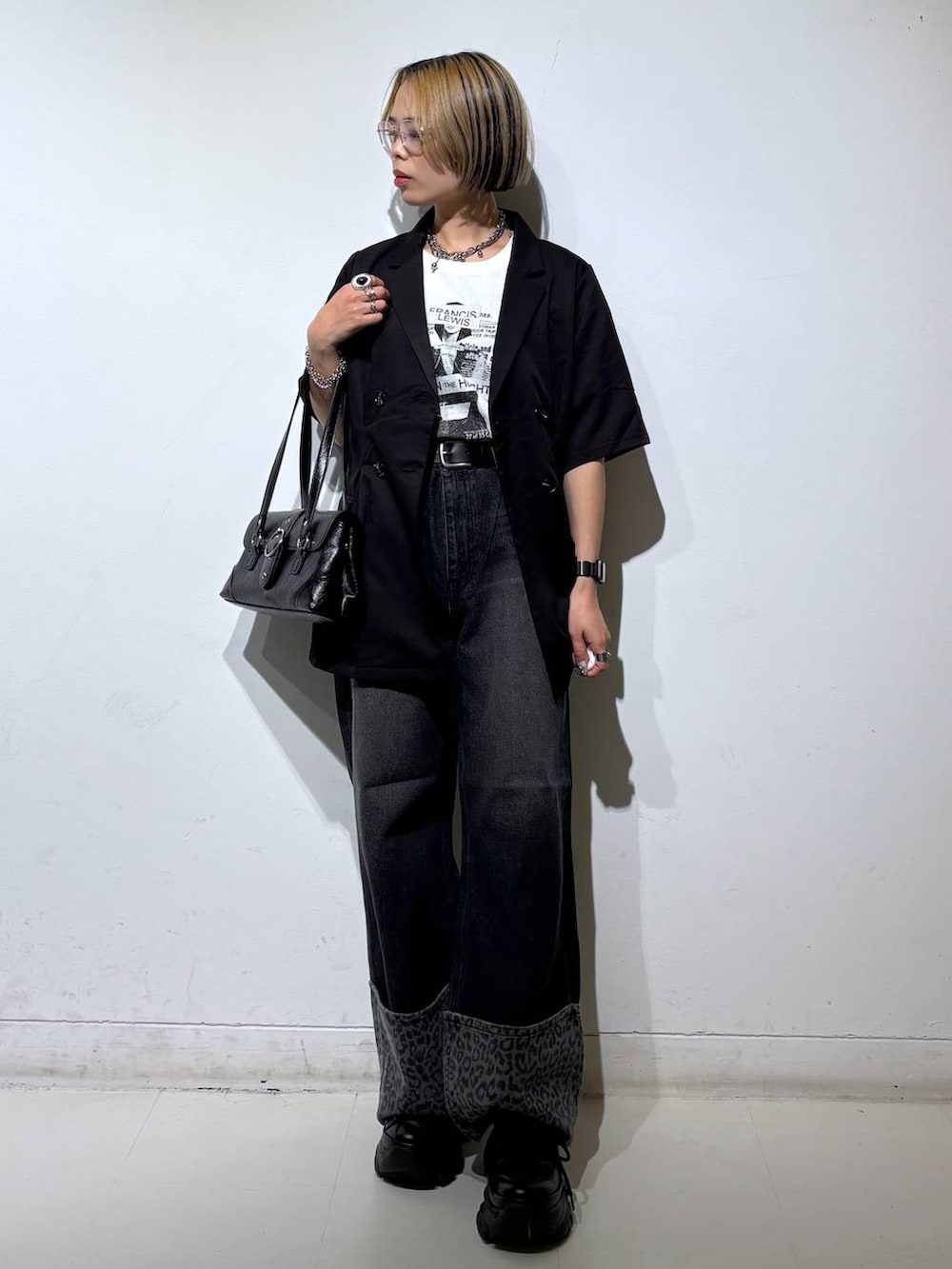 ホワイト系のTシャツ/カットソー、ブラック系のスニーカー、ブラック系のデニムパンツを着用したレディースの夏コーディネートの2枚目の写真