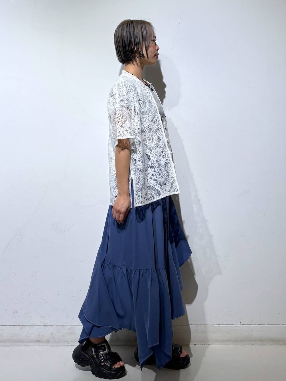 ホワイト系のシャツ/ブラウス、ブルー系のスカート、グレー系のTシャツ/カットソーを着用したレディースの春コーディネートの4枚目の写真