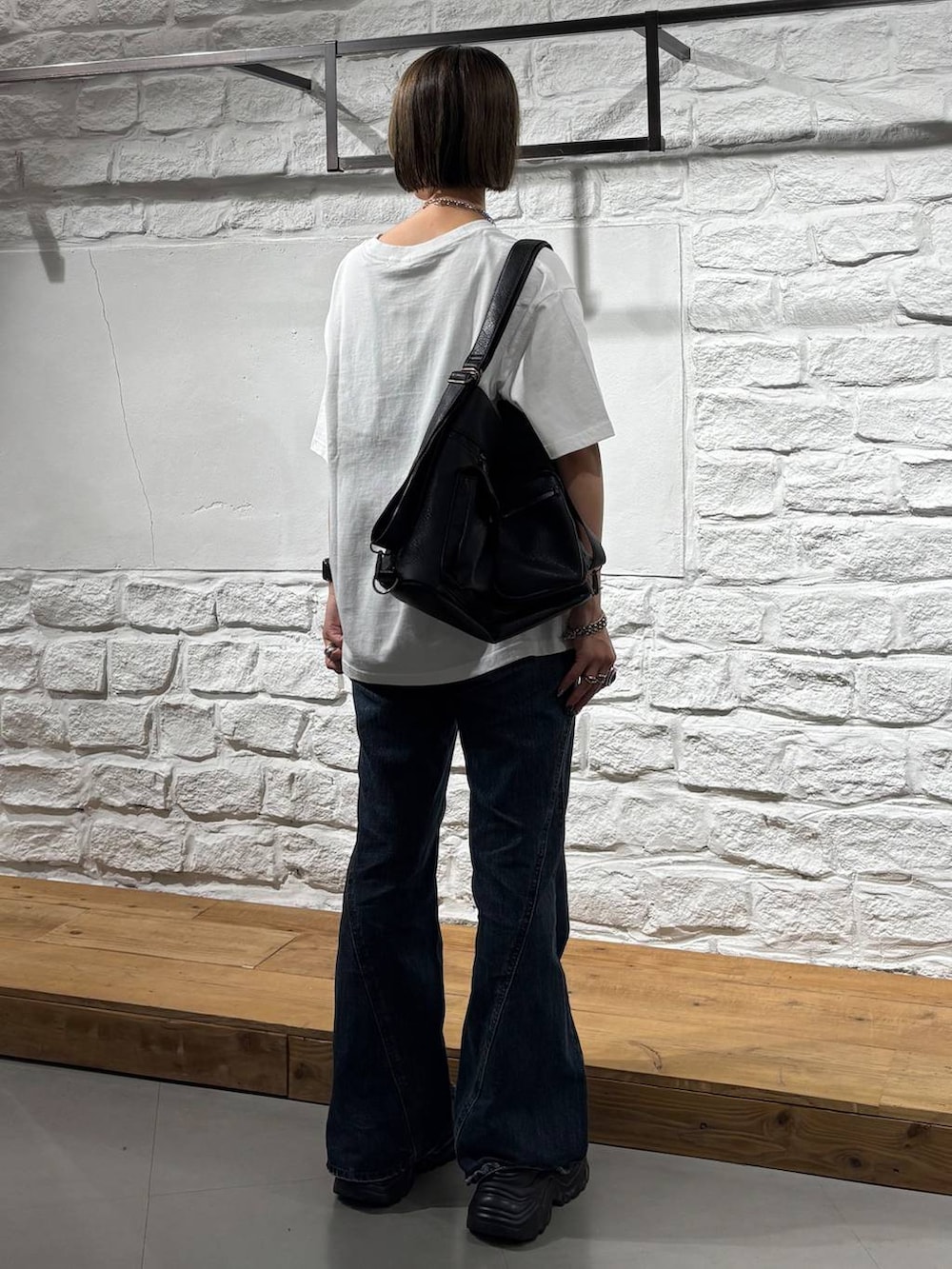 ホワイト系のTシャツ/カットソー、ブルー系のデニムパンツ、ブラック系のショルダーバッグを着用したレディースの夏コーディネートの6枚目の写真