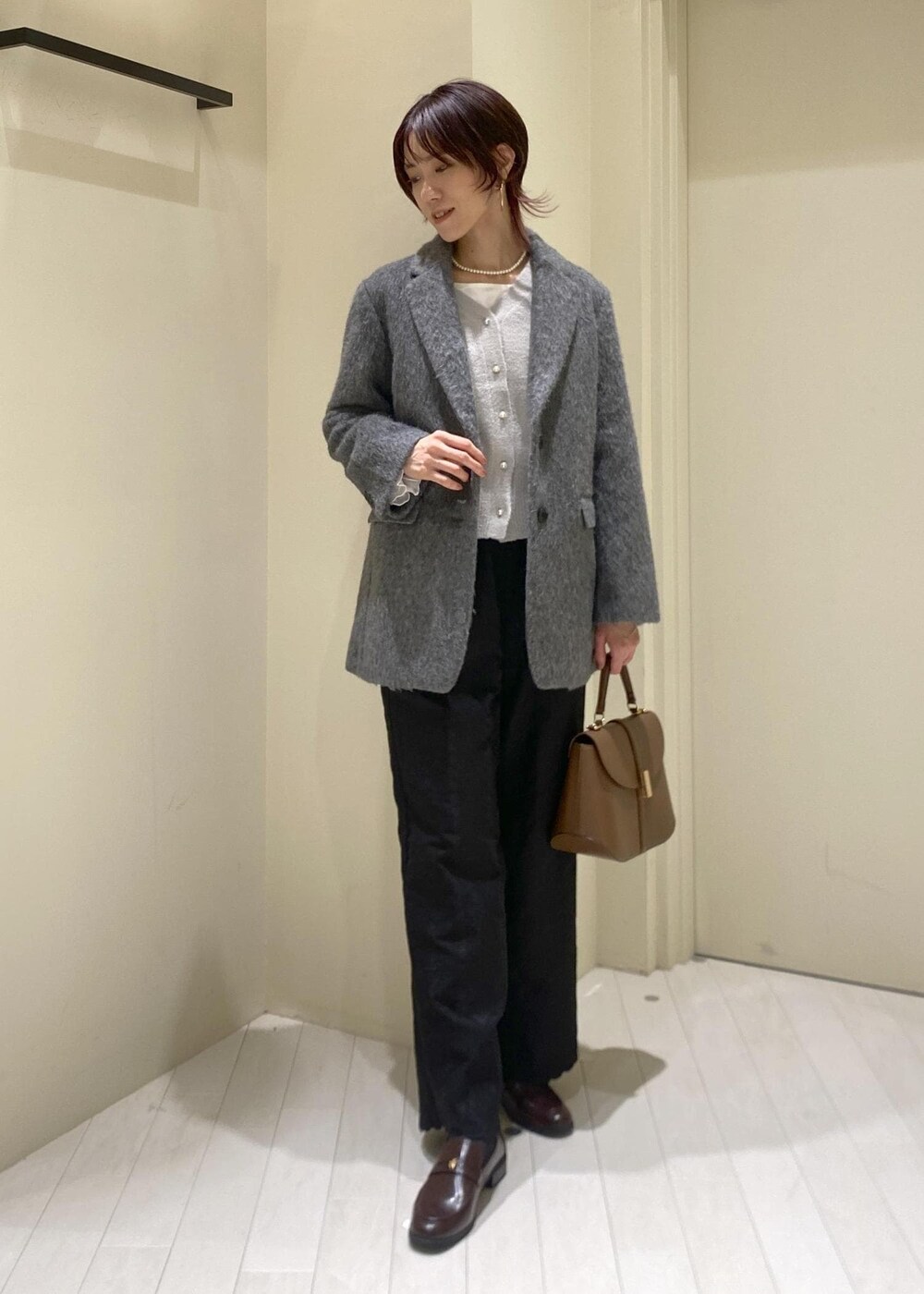 グレー系のカーディガン/ボレロ、ホワイト系のTシャツ/カットソー、グレー系のテーラードジャケットを着用したレディースの冬コーディネートの4枚目の写真