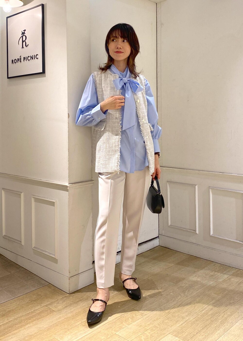 グレー系のベスト、イエロー系のその他パンツ、ブルー系のシャツ/ブラウスを着用したレディースの冬コーディネートの2枚目の写真