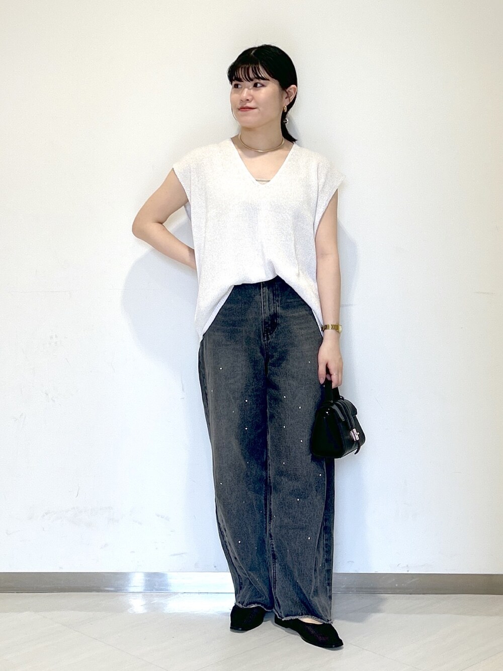 ベージュ系のキャミソール、ホワイト系のニット/セーター、ブラック系のショルダーバッグを着用したレディースの夏コーディネートの5枚目の写真