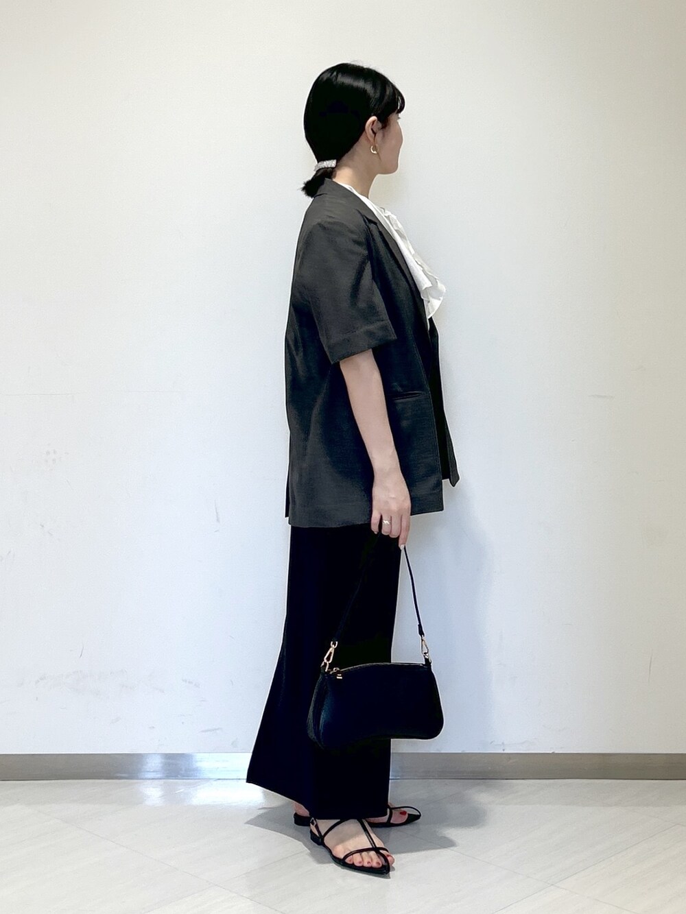 ホワイト系のシャツ/ブラウス、グレー系のテーラードジャケット、ブラック系のスカートを着用したレディースの夏コーディネートの5枚目の写真