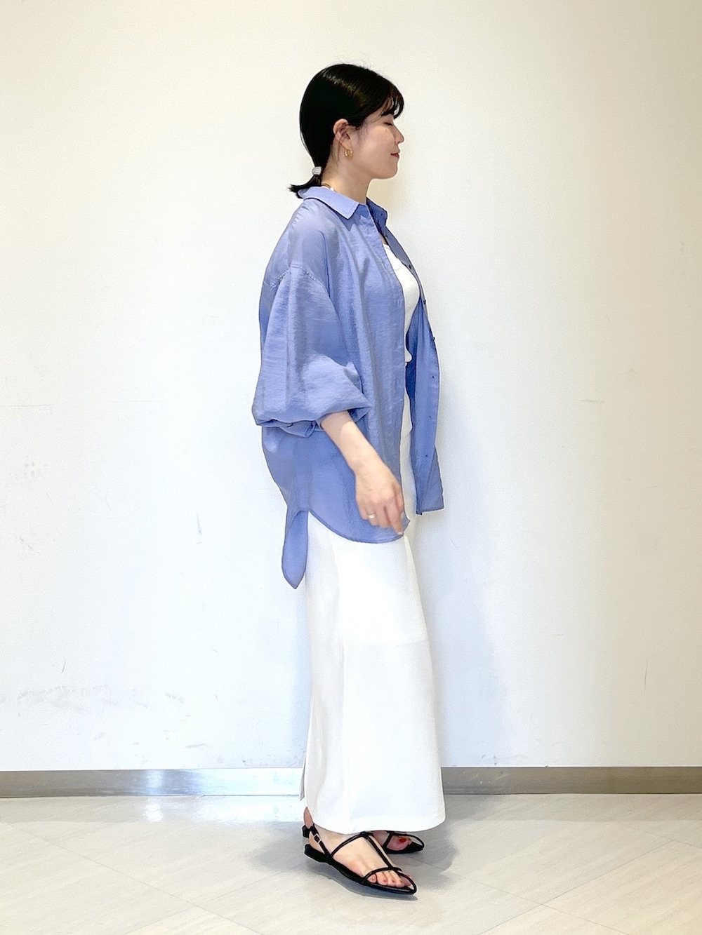 ブラック系のショルダーバッグ、ホワイト系のタンクトップ、ブルー系のシャツ/ブラウスを着用したレディースの夏コーディネートの5枚目の写真